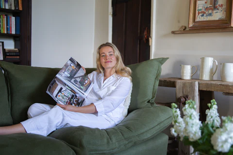 Marnie showing Troye Sivan article featuring Maker and Son Malachite green linen, Song pillow edge Sofa.