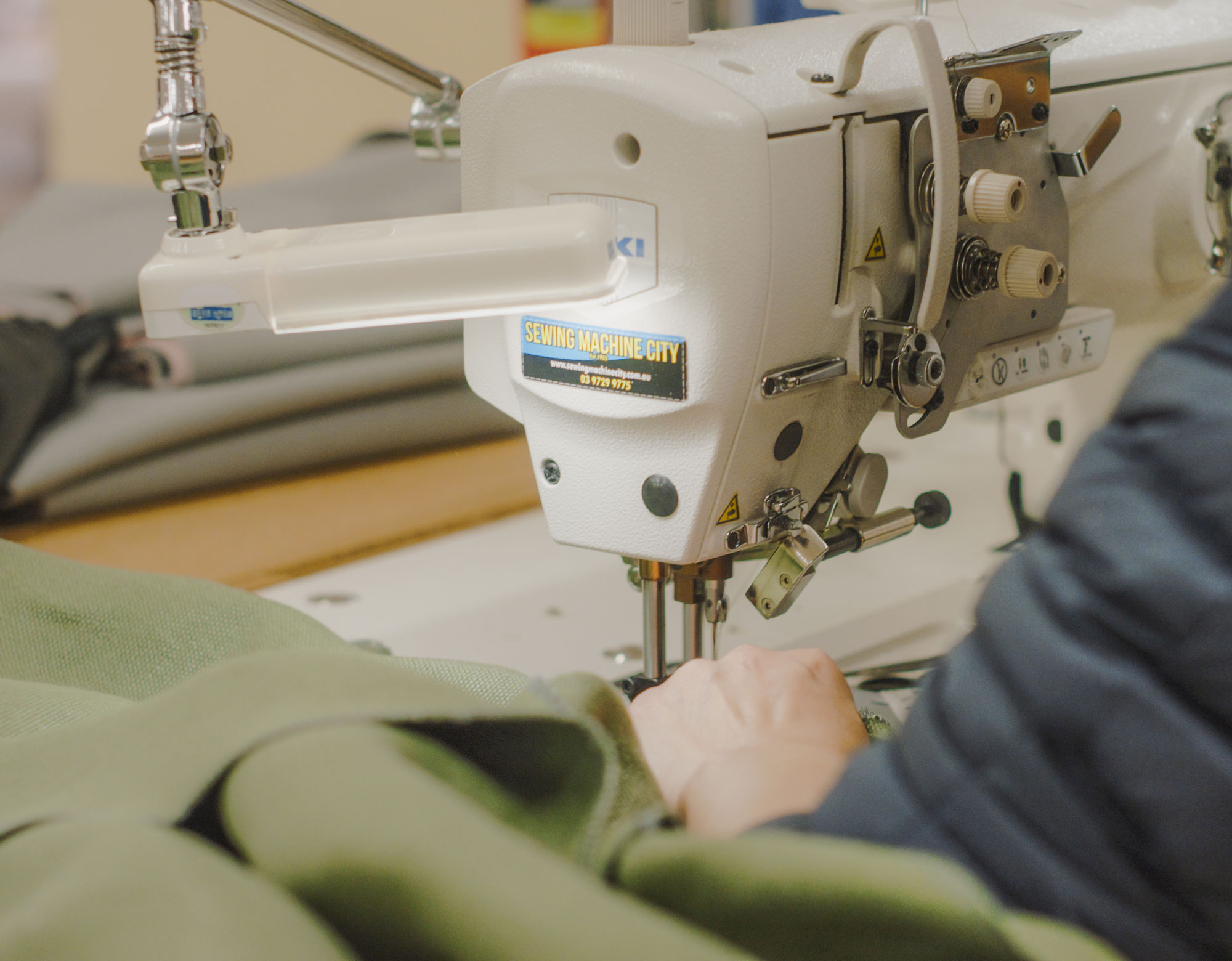 Maker and Son sofa covers being sewn from linen.